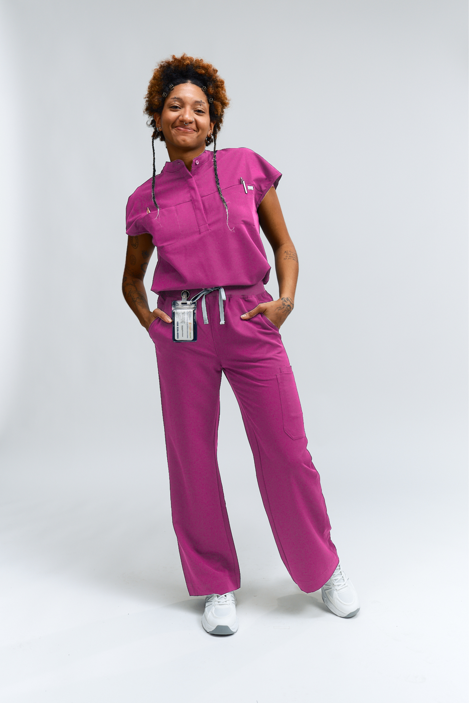 Person wearing a pink medical uniform on a white background