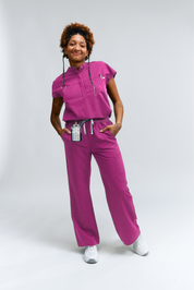 Person wearing a pink medical uniform on a white background